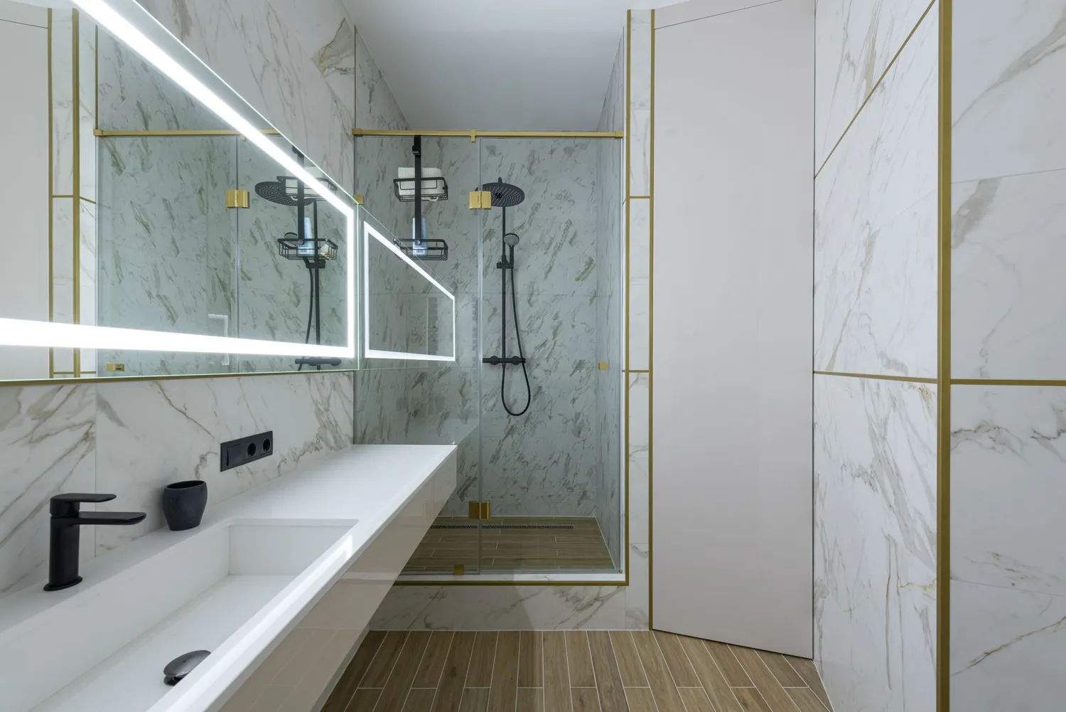 A bright modern bathroom with a marble shower and a large window