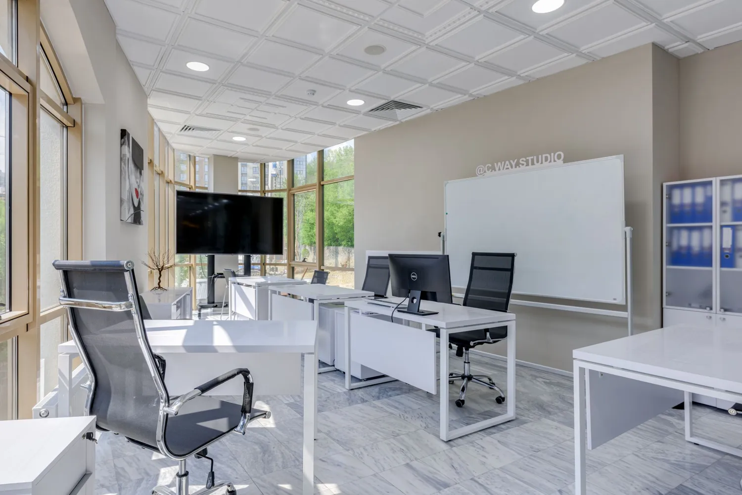 A bright, clean office with desks and large windows